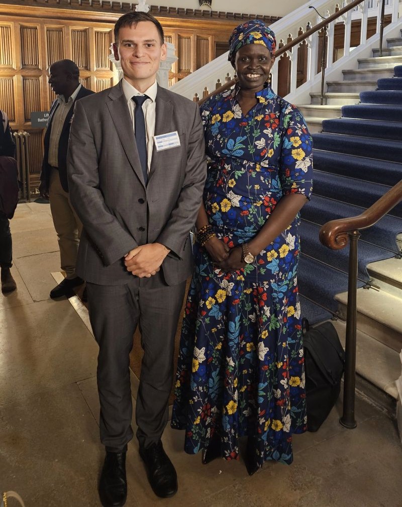 Angelina Jial standing beside a staircase at Lambeth Palace with a fellow participant