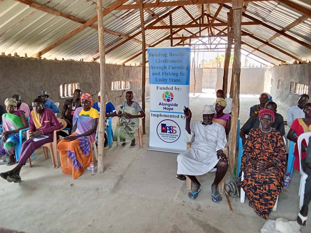 AAP committee members seated under a shelter during the training in Leer County