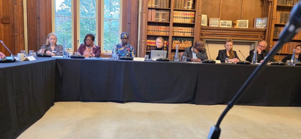 Participants seated around a table at the high-level meeting at Lambeth Palace, London